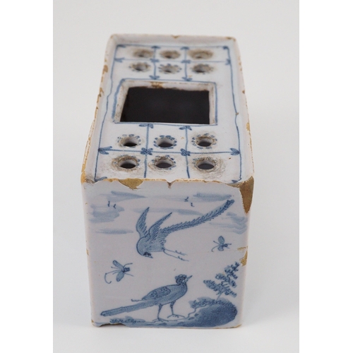 80 - An English delftware flower brick, mid 18th century, painted with Chinese figures in European landsc... 