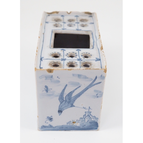 80 - An English delftware flower brick, mid 18th century, painted with Chinese figures in European landsc... 