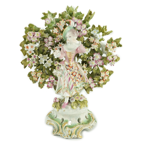 84 - A Bow porcelain bocage figure of a lady, c.1765, the lady standing before bocage on a flower encrust... 