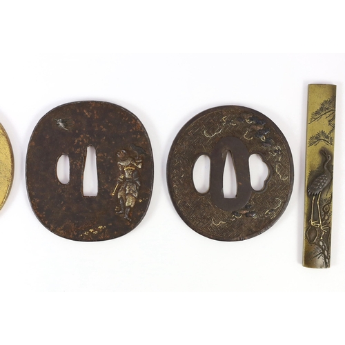 92 - A group of Japanese bronze, iron and mixed metal tsuba and a kozuka knife handle, 19th century, comp... 