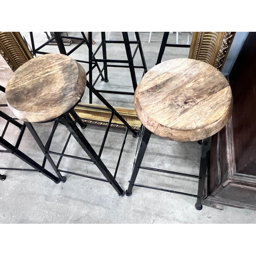 2002 - A set of four industrial style painted wrought iron bar stools with circular wooden seats, height 80... 