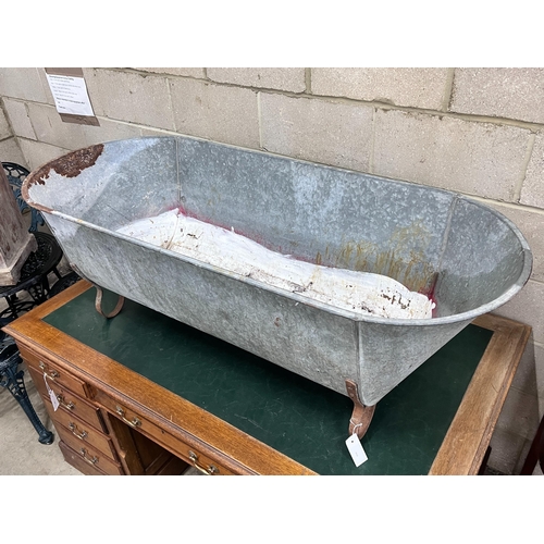 2025 - A vintage galvanised trough on wrought iron feet, length 146cm, depth 62cm, height 49cm