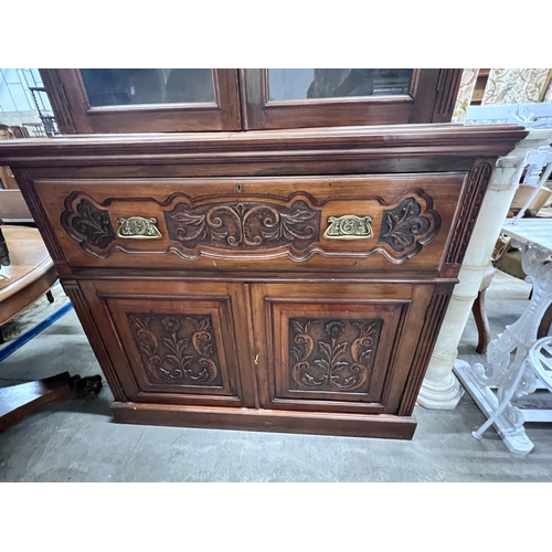 2043 - A late Victorian carved walnut secretaire bookcase, width 123cm, depth 48cm, height 234cm