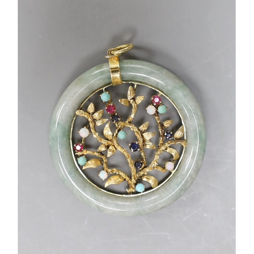 2977 - A 14k yellow metal and multi gem set circular jade pendant, diameter 51mm, gross weight 28.8 grams.... 