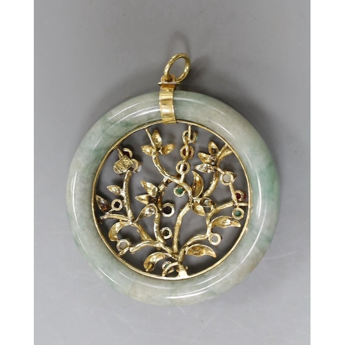 2977 - A 14k yellow metal and multi gem set circular jade pendant, diameter 51mm, gross weight 28.8 grams.... 