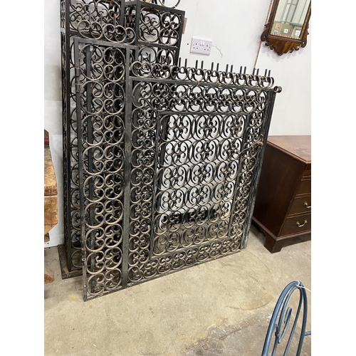 12 - A pair of black painted wrought iron scroll work gates with matching lantern posts, total width 286c... 