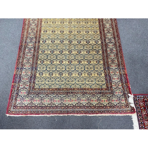 129 - An antique North West Persian faded peach ground rug, 200 x 148cm