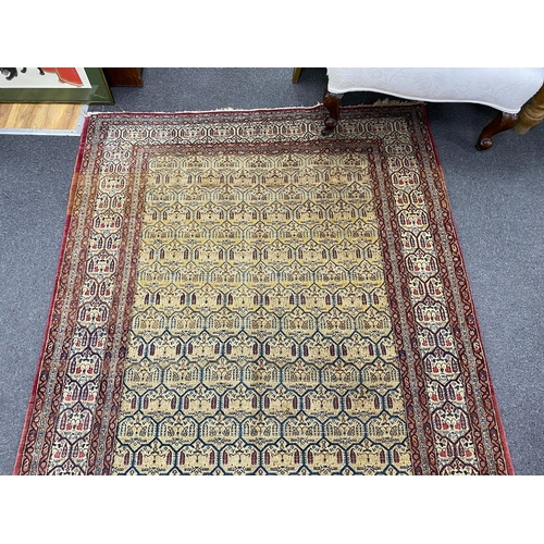 129 - An antique North West Persian faded peach ground rug, 200 x 148cm