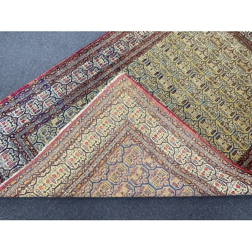 129 - An antique North West Persian faded peach ground rug, 200 x 148cm