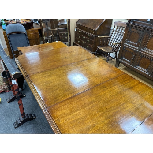 135 - An early Victorian mahogany extending dining table on fluted baluster legs with two leaves, 240cm ex... 