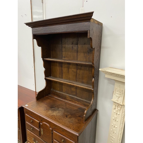 19 - An 18th century oak chest of drawers with later associated oak shelves, width 79cm, depth 46cm, heig... 