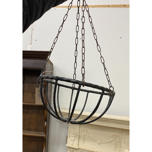 21 - Three metal hanging baskets, a wall mounted pot holder and a stand