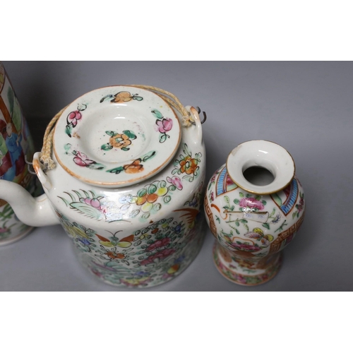 265 - Three Chinese famille rose vases and a teapot, late 19th/early 20th century, tallest vase 29.5 cms h... 