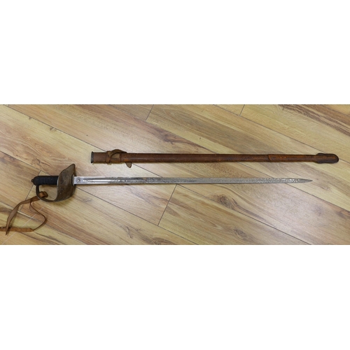 312 - A George V military dress sword in brown leather covered scabbard, 102cm long, and a Middle Eastern ... 