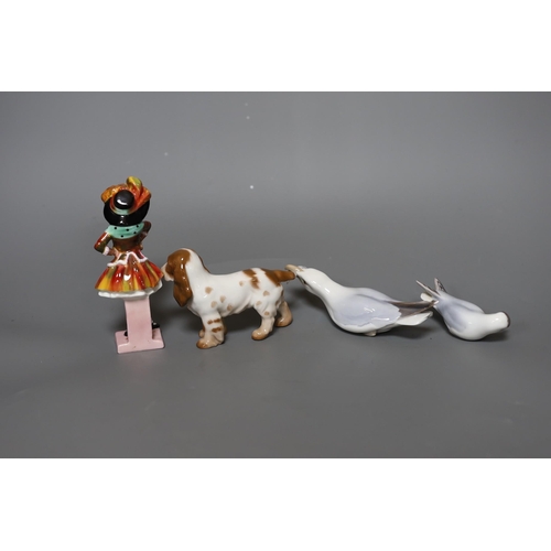 318 - A Royal Doulton figure,Party Girl, HN 2036, two Bing and Grondahl birds and a dog,figure 14 cms hi... 