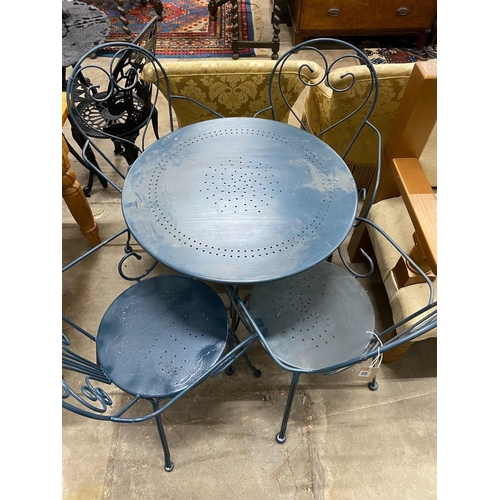 33 - A circular painted aluminium garden table, diameter 70cm, height 72cm and four chairs