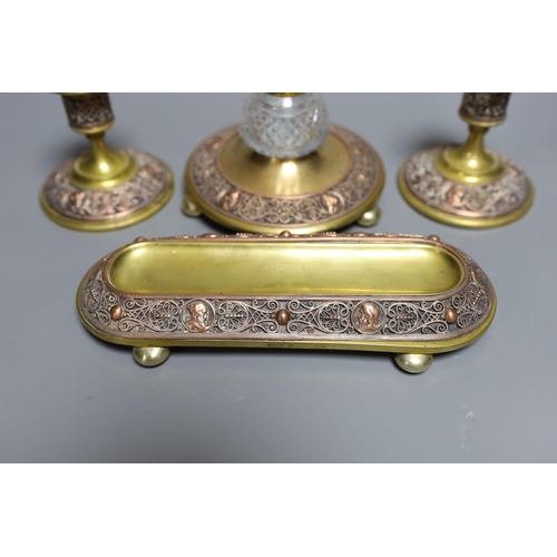 353 - A brass and filigree worked copper desk set (4),inkwell 10.5 cms high,