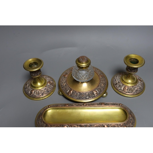 353 - A brass and filigree worked copper desk set (4),inkwell 10.5 cms high,