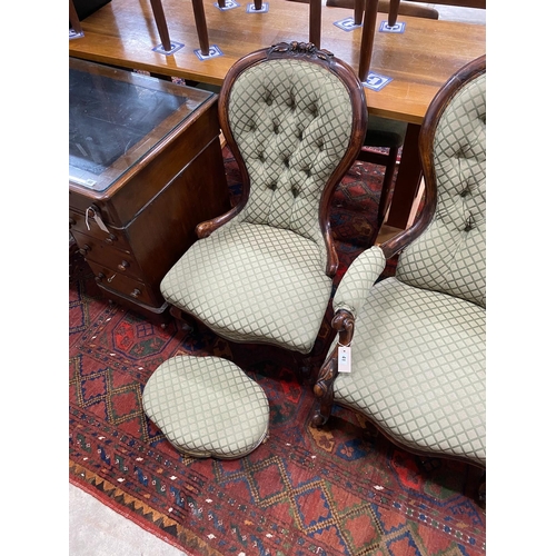 41 - A pair of Victorian carved walnut spoon back chairs, one with arms together with a similar footstool... 