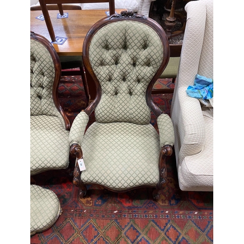 41 - A pair of Victorian carved walnut spoon back chairs, one with arms together with a similar footstool... 