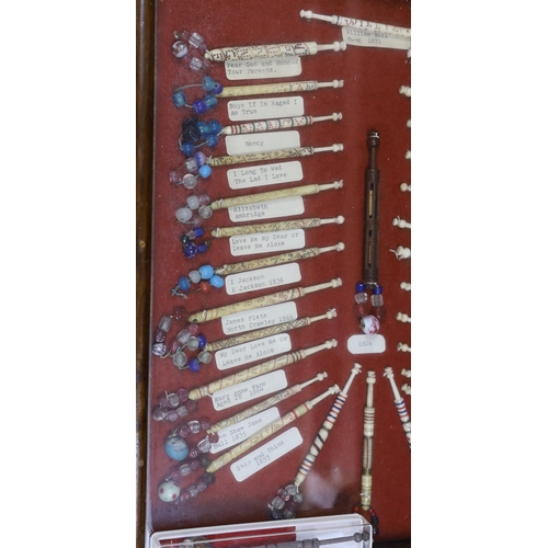 420 - A cased collection of 19th century inscribed bone and glass bead lace bobbins, some dated and named,... 