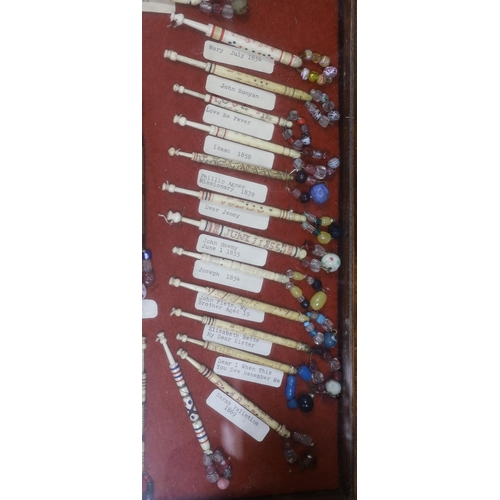 420 - A cased collection of 19th century inscribed bone and glass bead lace bobbins, some dated and named,... 