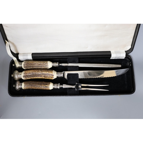 424 - A Greenwood and Sons stag antler handled carving set, in original box,