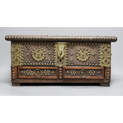 432 - An Indian brass studded and mounted box, 45cms wide x 21cms high,