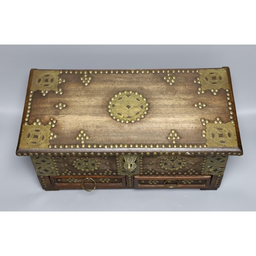 432 - An Indian brass studded and mounted box, 45cms wide x 21cms high,