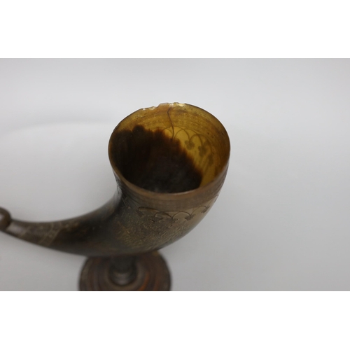 441 - A Persian horn rhyton, 19th century or earlier, with horn stem and stepped wood base, 21cms high, 20... 