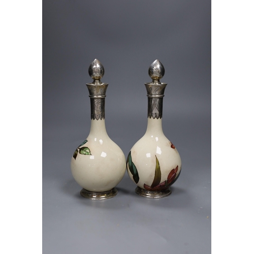 472 - A pair of Victorian silver mounted Art pottery scent bottles,21.5cms high including stopper,... 