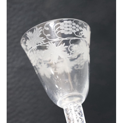 494 - An 18th century engraved air twist stem wine glass, 15cm tall