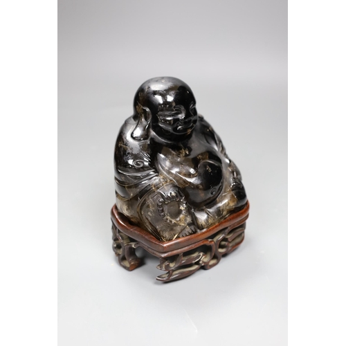 498 - A large Chinese smoky quartz figure of Budai, 17cm tall including wood stand