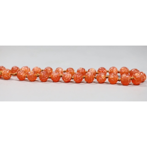 508 - A Chinese chalcedony bead necklace, carved with medallion motifs, early 20th century