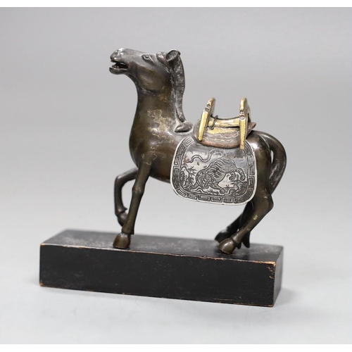 512 - A Chinese bronze mixed metal figure a saddled horse, late 19th/early 20th century, wood stand,8.5cms... 