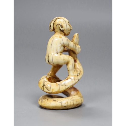 530 - A 19th century native American marine ivory group of a warrior wrestling a snake, 7cm high,