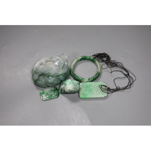 540 - A group of five Chinese jadeite carvings, including two pendants and a bangle, largest 11cms long,... 