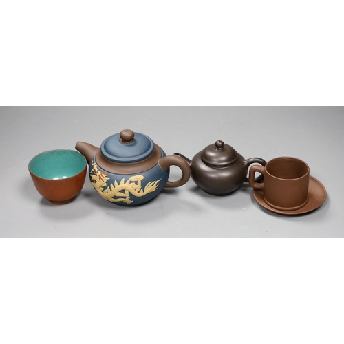 562 - A 19th century Chinese Yixing cup, two later teapots and a cup and saucer