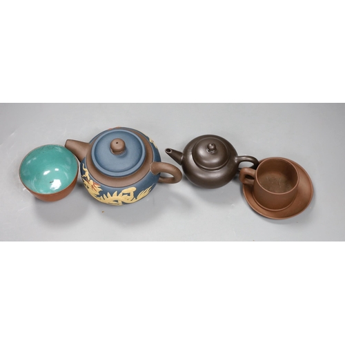 562 - A 19th century Chinese Yixing cup, two later teapots and a cup and saucer