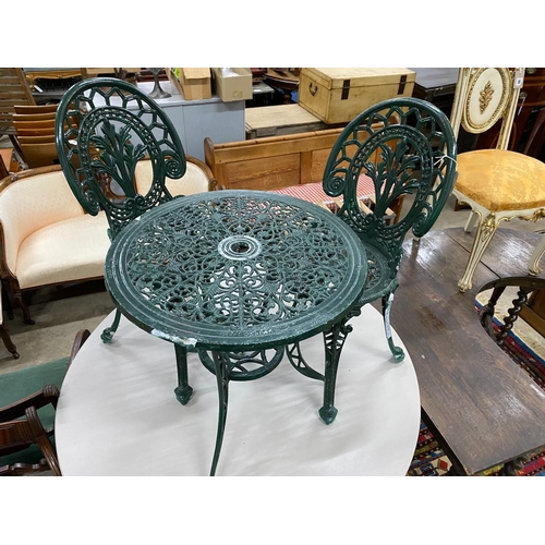 64 - A Victorian style aluminium garden table, diameter 60cm, height 62cm and two chairs