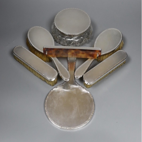 800 - A 1960's seven piece engine turned silver backed brush, mirror and powder bowl set.