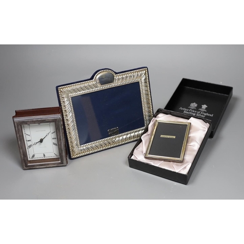 822 - Two modern silver mounted photograph frames and a similar silver mounted Mappin & Webb timepiece, 10... 