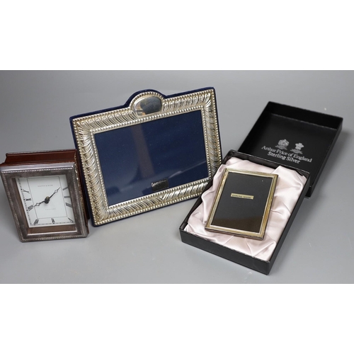 822 - Two modern silver mounted photograph frames and a similar silver mounted Mappin & Webb timepiece, 10... 