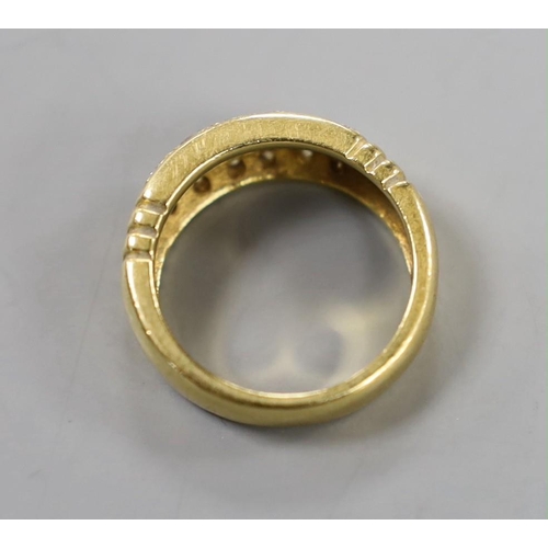 883 - A yellow metal and eighteen stone pave set diamond ring, size Q/R, gross weight 10.7 grams.