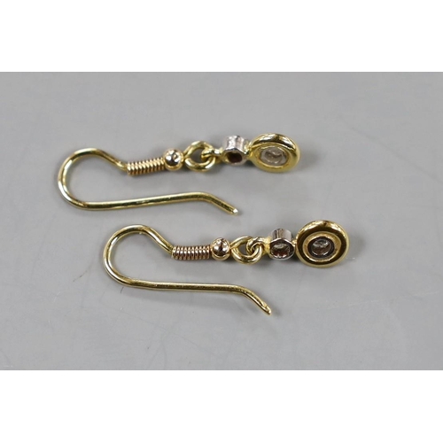 886 - A pair of yellow metal and two stone diamond set drop earrings, overall 25mm, gross weight 2.1 grams... 