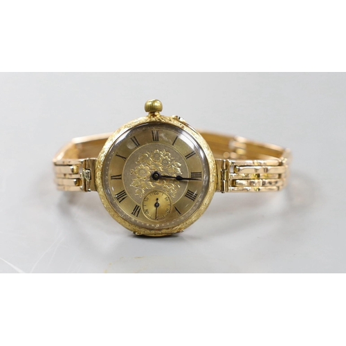 890 - An early 20th century engraved 18ct gold fob watch, now converted to a wrist watch on a later expand... 