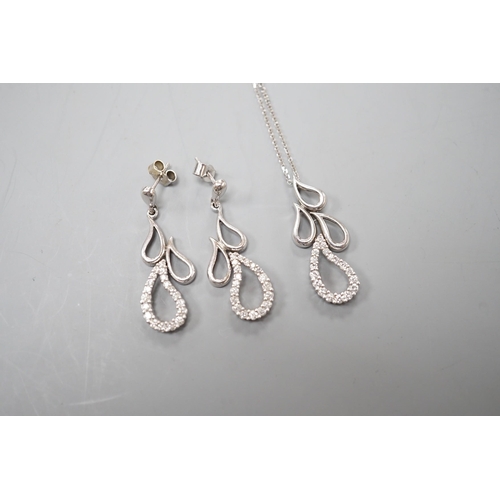 904 - A modern white metal and diamond set quadruple teardrop shaped cluster drop pendant, 28mm, on a 9ct ... 