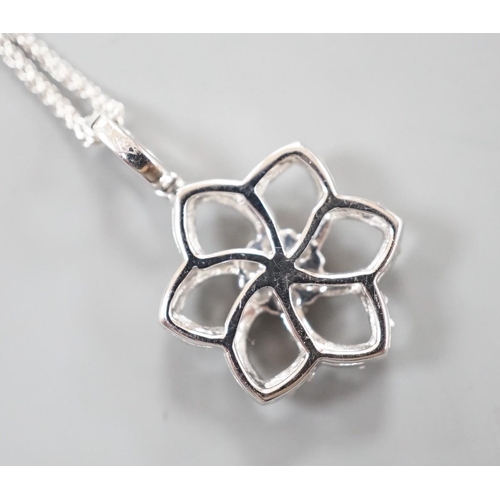 910 - A modern 750 white metal and diamond chip set openwork flower head cluster pendant, overall 24mm, on... 