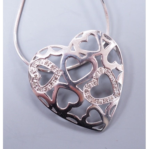 911 - A modern 9k white metal and diamond chip set open work heart pendant, 26mm, on a 9ct white gold fine... 