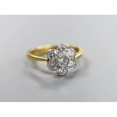 912 - A modern 18ct gold and seven stone collet set diamond flower head cluster ring, size O, gross weight... 